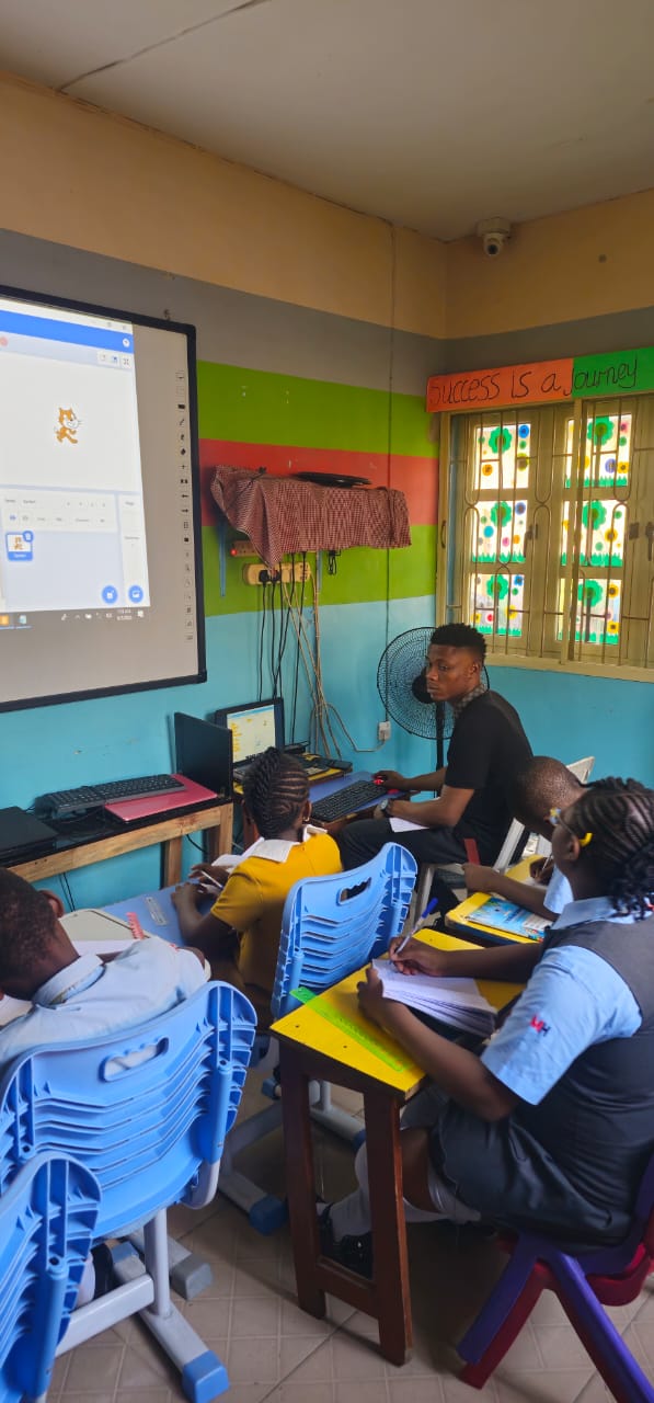 Pupils at the school logo wall